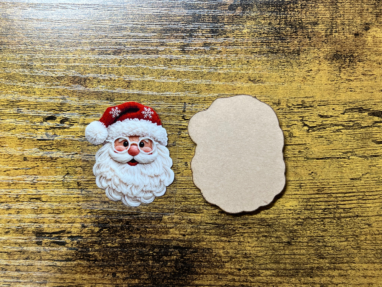 Clear acrylic blank with UV DTF decal featuring Santa with faux yarn, used for badge reels or keychains.