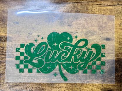 Retro Lucky shamrock heat transfer, white distressed clover graphic with checkerboard accents for ready-to-press apparel.