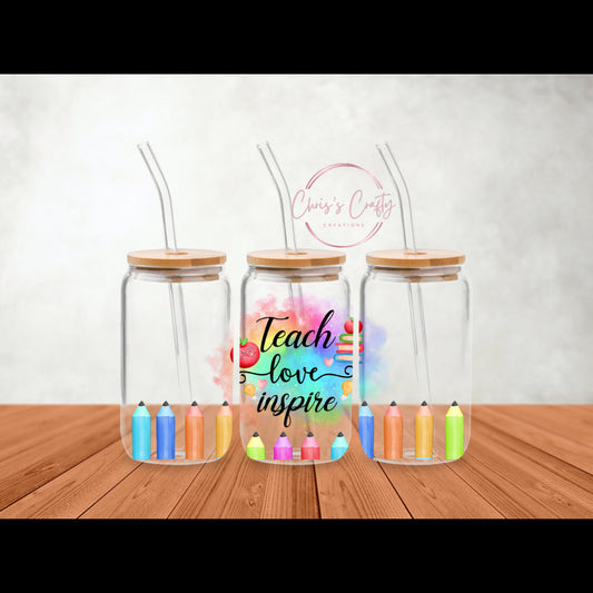 Mockup of the Teach Love Inspire UV DTF wrap applied to a 16oz frosted glass can with a bamboo lid and glass straw